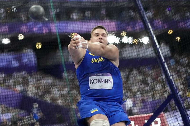 Mykhaylo Kokhan, of Ukraine, competes in the men's hammer throw final at the 2024 Summer Olympics, Sunday, Aug. 4, 2024, in Saint-Denis, France. (AP Photo/Bernat Armangue)