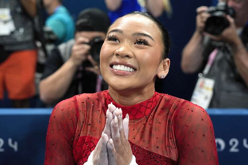 Suni Lee, of the United States, celebrates after winning the bronze medal during the women's artistic gymnastics individual uneven bars finals at Bercy Arena at the 2024 Summer Olympics, Sunday, Aug. 4, 2024, in Paris, France. (AP Photo/Charlie Riedel)