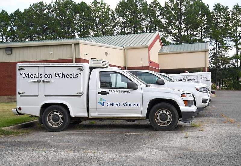 Meals on Wheels delivery trucks are shown parked outside the CHI St. Vincent McAuley Senior Center off Highway 7 north on Wednesday. (The Sentinel-Record/Donald Cross)