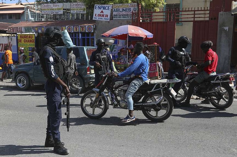 Police stop motorcyclists as they patrol in Port-au-Prince, Haiti, Friday, Aug. 23, 2024. (AP Photo/Odelyn Joseph)