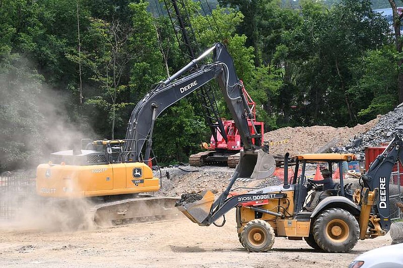 Workers operate heavy equipment in June near the site of the new wet weather/peak flow sewer pump station being built on Catherine Heights Road. (The Sentinel-Record/Donald Cross/File)