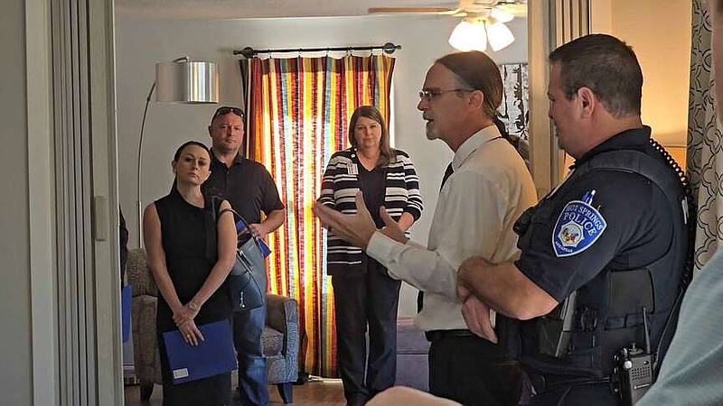 The Hope Movement Executive Director Marty Haynes, second from right, gives a tour of the nonprofit's home for women Thursday. (The Sentinel-Record/Donald Cross)