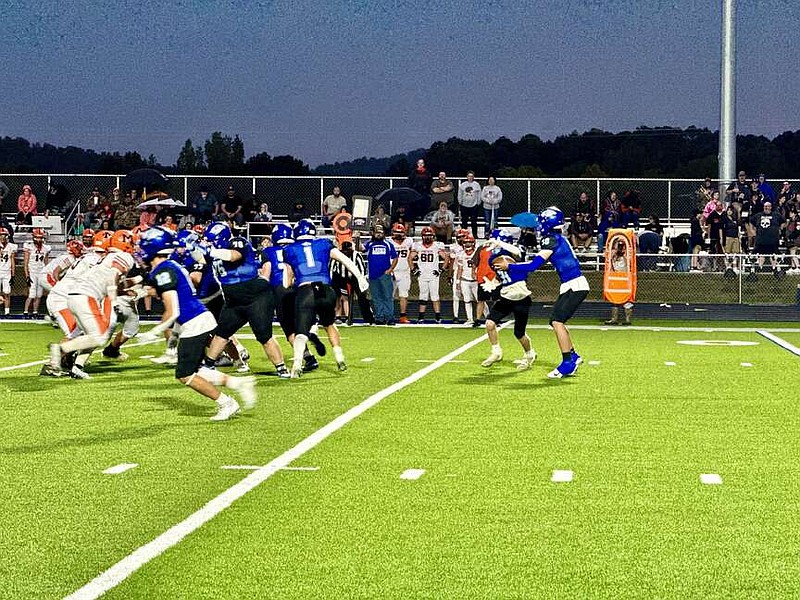 Jessieville senior quarterback Dalton Ellison (10) hands the ball off to Lions senior running back Gage Gaston on Friday against Magnet Cove at Don Phillips Field. (The Sentinel-Record/Bryan Rice)