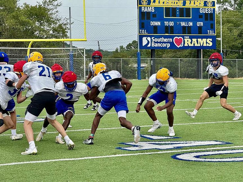 Lakeside junior running back Tremendous Cain (6), center, runs the ball during practice on Sep. 4 at Rams Field. (The Sentinel-Record/Bryan Rice)