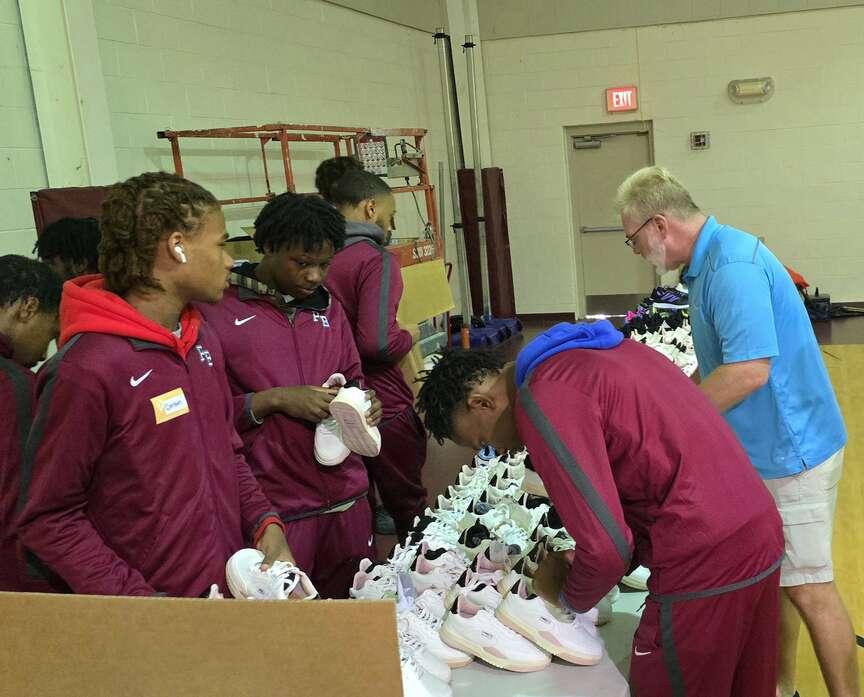 Razorback players help distribute 500 pairs of shoes to kids