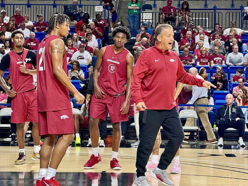 Arkansas Razorbacks head men's basketball coach John Calipari demonstrates how to run a drill during Saturday's Tip-Off Tour at Bank OZK Arena. (The Sentinel-Record/Bryan Rice)