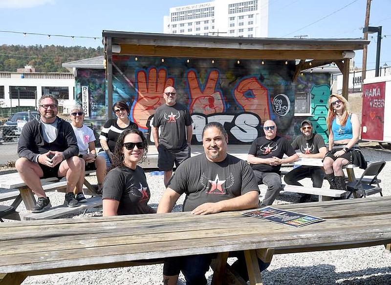 Dean Agus, front right, event director and coordinator for the Seventh Annual Spa City Rocktober Music Festival, gathers Tuesday with other organizers for the event, set to begin at 11 a.m. Saturday at 420eats, located at 420 Malvern Ave., and owned by Stephen Inman-Crawley, far left. (The Sentinel-Record/Donald Cross)