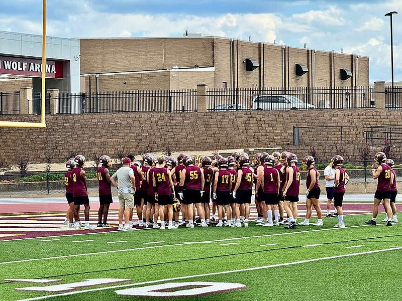 The Lake Hamilton Wolves football team meets in the end zone at Wolf Stadium on Sep. 26. The Wolves travel to Greenwood tonight to face the Bulldogs. (The Sentinel-Record/Bryan Rice)