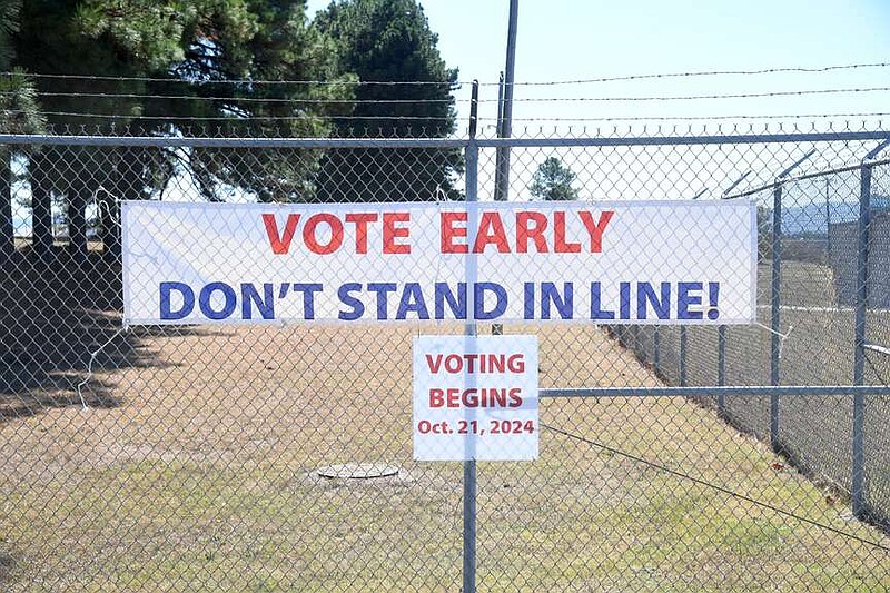 A sign promoting early voting is shown on the fence of the Bill Edwards Center, 517 Airport Road, on Friday. (The Sentinel-Record/Donald Cross)