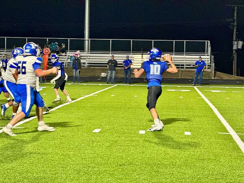 Jessieville senior quarterback Dalton Ellison sets to throw a pass against the Paris Eagles on Friday. The Lions beat the Eagles 30-23 at Phillips Field. (The Sentinel-Record/Bryan Rice)