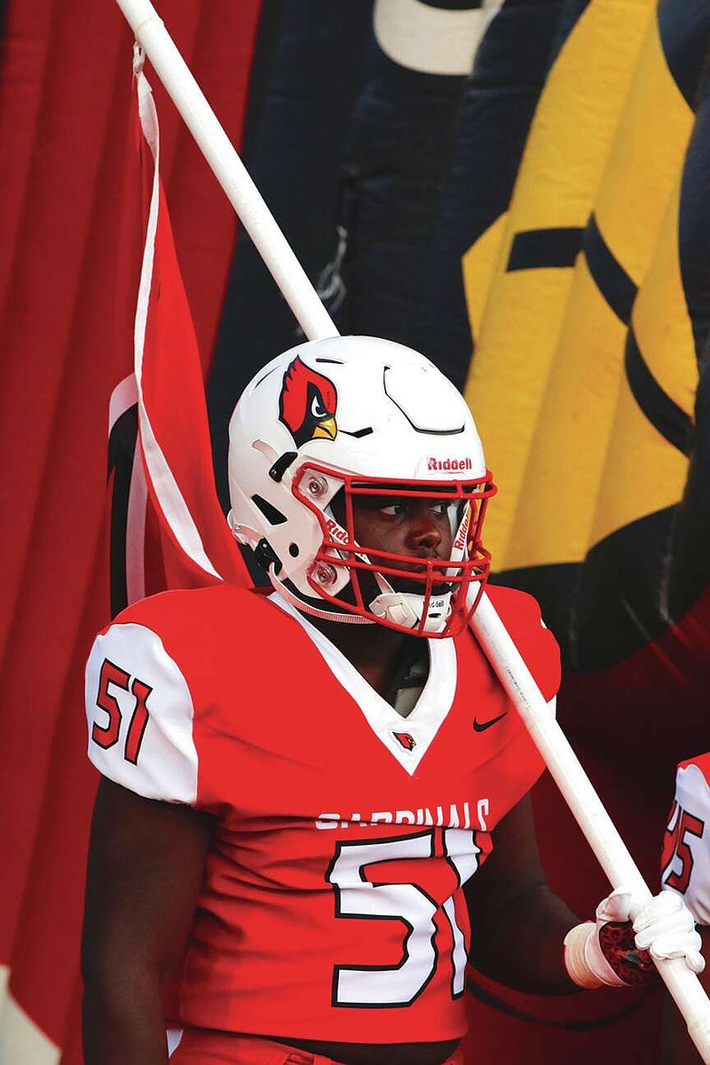 Photo via CFHS Yearbook
Game Face
Camden Fairview linemen Jordan McCoy carries the flag during a home game from earlier in the season. The Cardinals defeated the Leopards 63-7 during Homecoming.