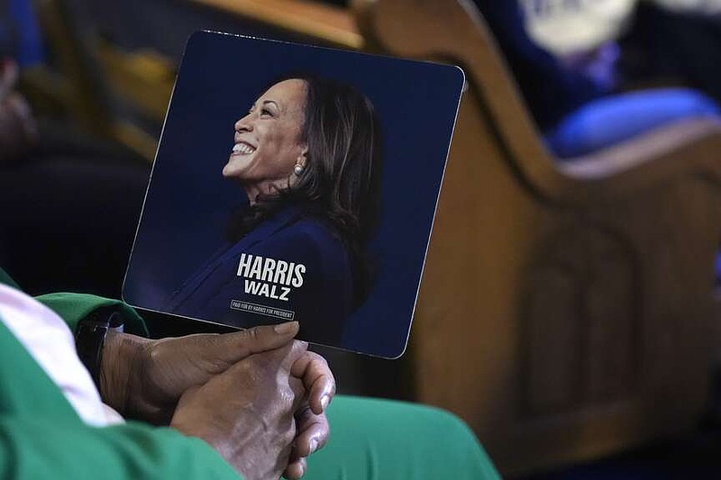 An attendee holds a campaign fan before Democratic presidential nominee Vice President Kamala Harris arrives to speak during a church service and early vote event at Divine Faith Ministries International, Sunday, Oct. 20, 2024, in Jonesboro, Ga. (AP Photo/Jacquelyn Martin)