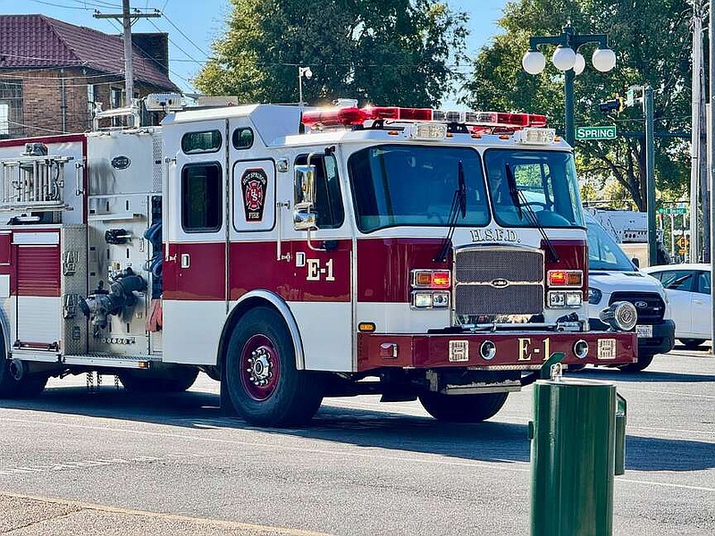 Engine No. 1 heads down Spring Street Wednesday. The pump truck is based at Central Station on Broadway Street. (The Sentinel-Record/Bryan Rice)