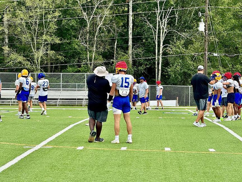 Lakeside Rams head football coach Garren Rockwell, left, coaches junior receiver Luke Wrublesky (15) during a Sept. 4 practice at Rams Field. (The Sentinel-Record/Bryan Rice)