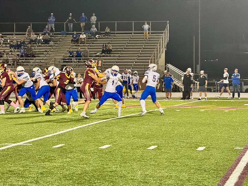 Mountain Home junior quarterback Barrett Miller drops back to pass in Friday night's 6A West Conference game with Lake Hamilton at Wolf Stadium. (The Sentinel-Record/Bryan Rice)