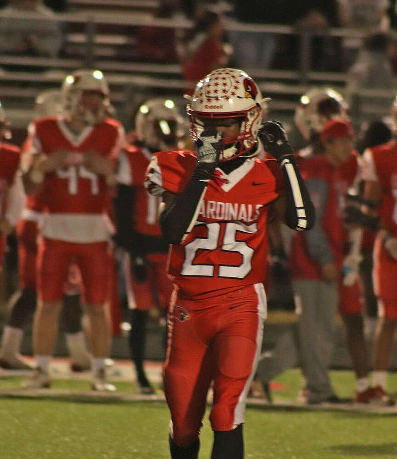 Hunting season
Sophomore cornerback DaKylan “Buddy” Hunter adjust his chin straps after a big hit during Friday's game. The Cardinal defense got its second shut-out of the season and its first shut-out in conference play against Hope last Friday.