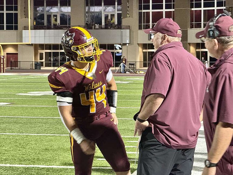 Lake Hamilton senior running back Hayden Barton (44) visits with Wolves head coach Tommy Gilleran on the sideline during Friday's game at Wolf Arena. (The Sentinel-Record/Bryan Rice)