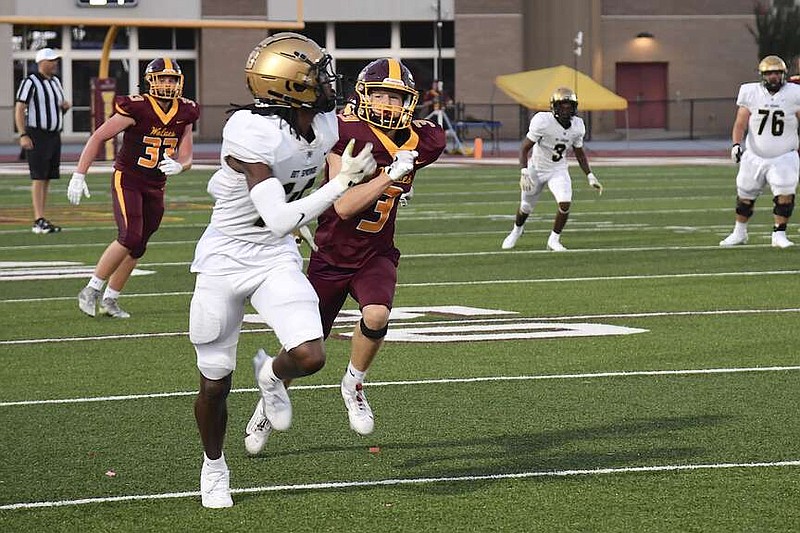 The Trojans' Ja'Marcis Morning goes out for a pass in Hot Springs' Aug. 20 scrimmage against Lake Hamilton at Wolf Stadium. (The Sentinel-Record/Donald Cross)