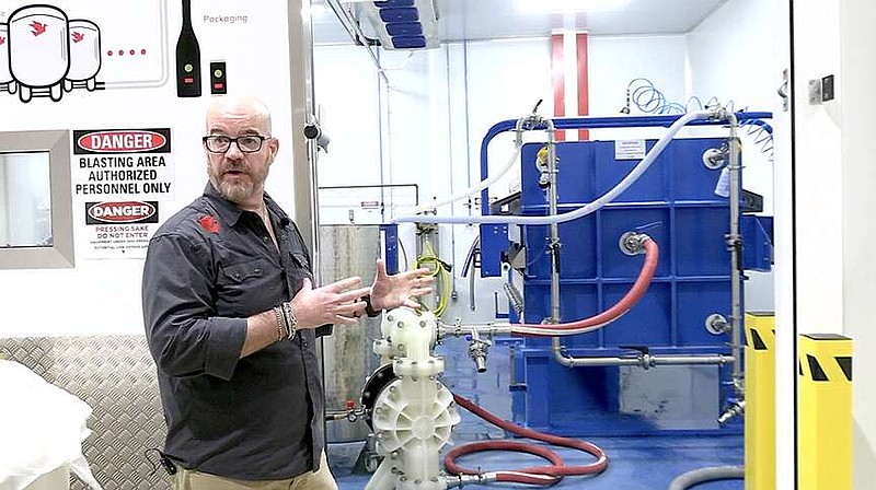 Matt Bell, co-founder and president of Origami Sake, explains the brewery's filtration system. (The Sentinel-Record/Donald Cross)