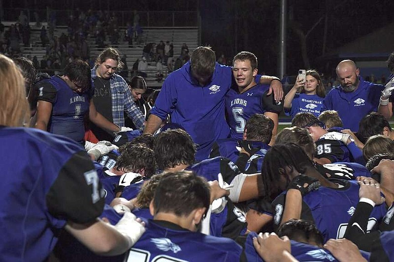 The Lions pray on the field following their 20-14 win at home over Perryville last week. (The Sentinel-Record/Donald Cross)