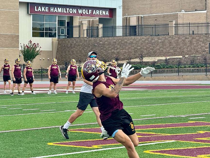 A Lake Hamilton football player catches a pass during practice drills on Sep. 26 at Wolf Stadium. The Wolves host Russellville tonight. (The Sentinel-Record/Bryan Rice)