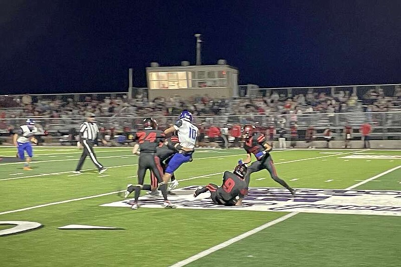 Jessieville quarterback Dalton Ellison (10) is tackled by a Cutter Morning Star defender during the first quarter Thursday night at Eagle Stadium. The Lions won 54-32. (The Sentinel-Record/Braden Sarver)