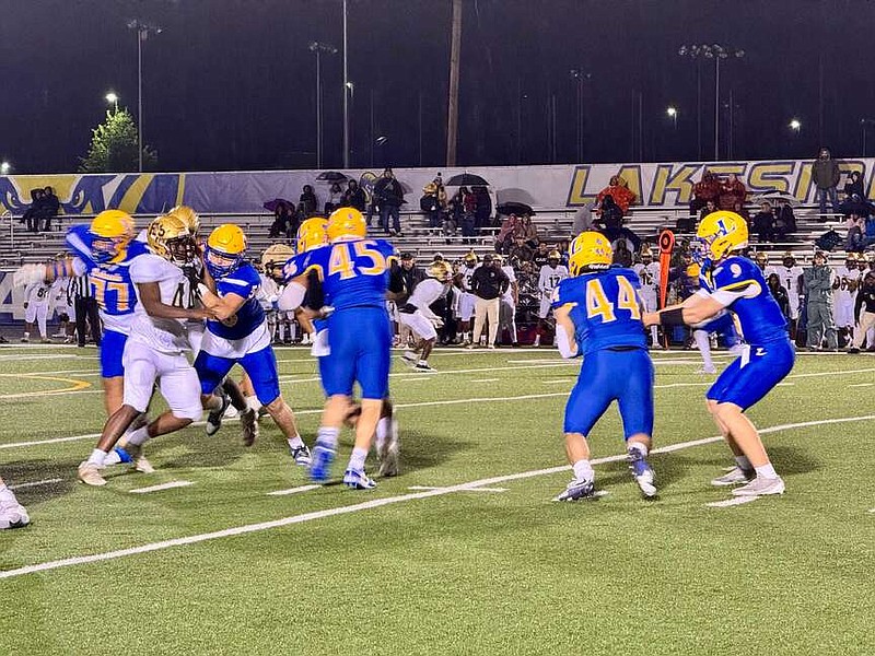 Lakeside running back senior Grady Ohman (44) takes a handoff from junior quarterback Wally Wolcott (9) in the Battle for Bathhouse Row on Friday between Lakeside and Hot Springs. (The Sentinel-Record/Bryan Rice)