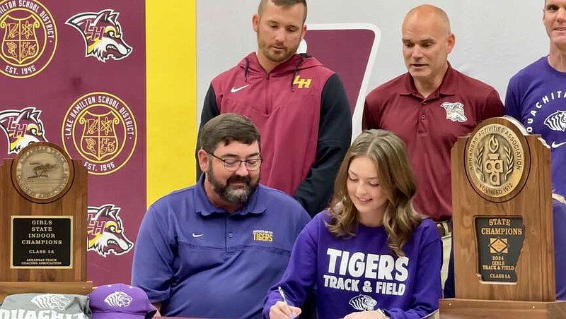 Lake Hamilton senior cross-country runner Lani Inman signs with Ouachita Baptist University on Wednesday at Wolf Arena. (The Sentinel-Record/Bryan Rice)