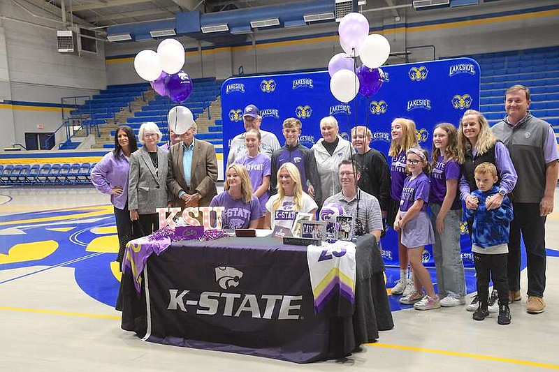 Lakeside senior volleyball player Lauren Latham, seated center, is pictured with her family and friends on Wednesday at Lakeside Sports Complex after signing her National Letter of Intent to play volleyball at Kansas State University. (The Sentinel-Record/Donald Cross)