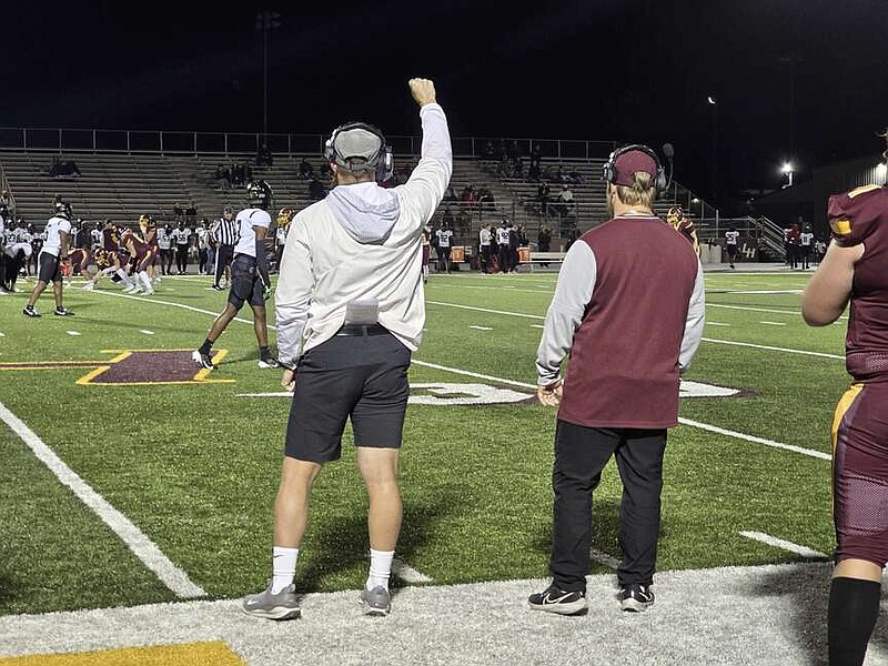 Lake Hamilton assistant coach Dale Gilleran raises his fist as the Wolves and Jonesboro Hurricane prepare for a down Friday night at Wolf Stadium. The Wolves won 41-27. (The Sentinel-Record/Donald Cross)