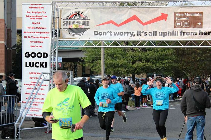 A group of runners cross the finish line at the Spa Running Festival on Saturday morning. (The Sentinel-Record/Braden Sarver)