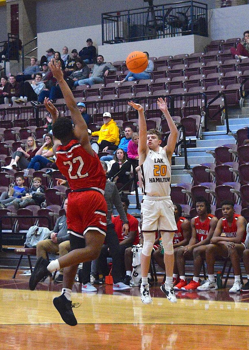 Lake Hamilton's Wyatt Ray (20), a junior this season, shoots during a game last season at home against Magnolia. The Wolves defeated Vilonia 53-32 in their season opener Tuesday night at Wolf Stadium. (The Sentinel-Record/Bryan Rice)