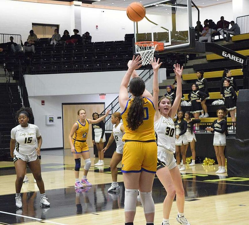 Hot Springs' Beth Ann Mullenix (30), a senior this season, tries to contest a Sheridan player's shot last season during a home game at Trojan Arena. The Trojans travel to Glen Rose tonight. (The Sentinel-Record/Bryan Rice)