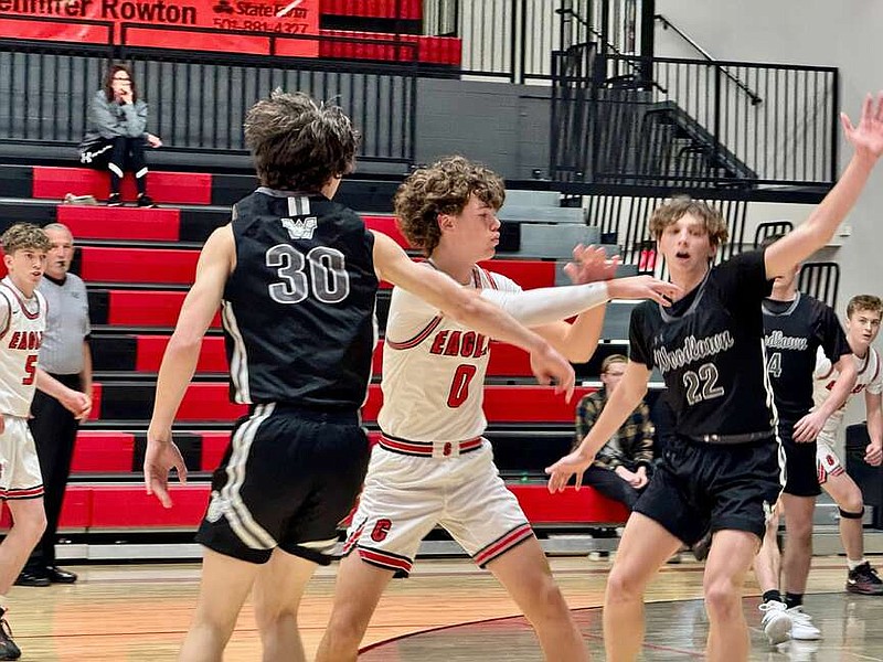 Cutter Morning Star sophomore Hunter Sanders (0) passes the ball to avoid a trap set by Woodlawn's Jake Allred (30) and Jack Lephiew (22) in Tuesday night's game at Eagle Arena. (The Sentinel-Record/Bryan Rice)