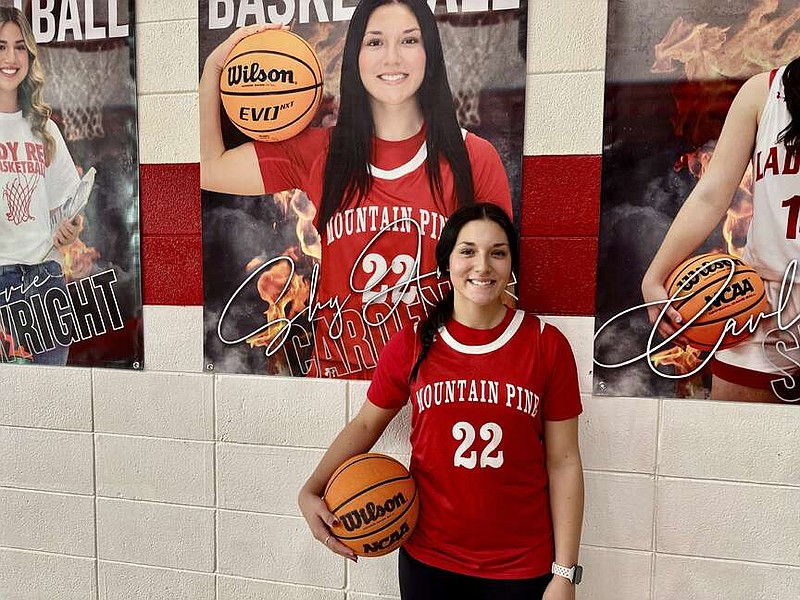 Mountain Pine senior guard ShyAnne Cardenas stands below her player banner inside Red Devil Field House on Nov. 14. (The Sentinel-Record/Bryan Rice)