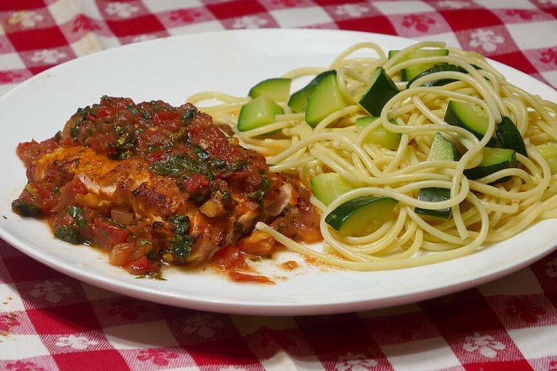 Here's a simple and quick way to cook salmon fillet. Just place it under a broiler for 3 to 4 minutes. Tomatoes cook down to a thick sauce in about 5 minutes and add a colorful topping to the broiled salmon. The spaghetti and zucchini are cooked together for the side dish. (Handout/TNS)