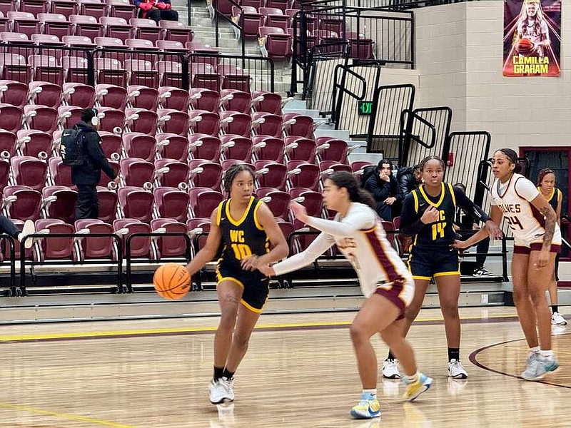 Watson Chapel senior guard Kha'Leyce Cooper (10) dribbles to avoid Lake Hamilton defender junior Disyah Christon (21) in Tuesday night's game at Wolf Arena. (The Sentinel-Record/Bryan Rice)