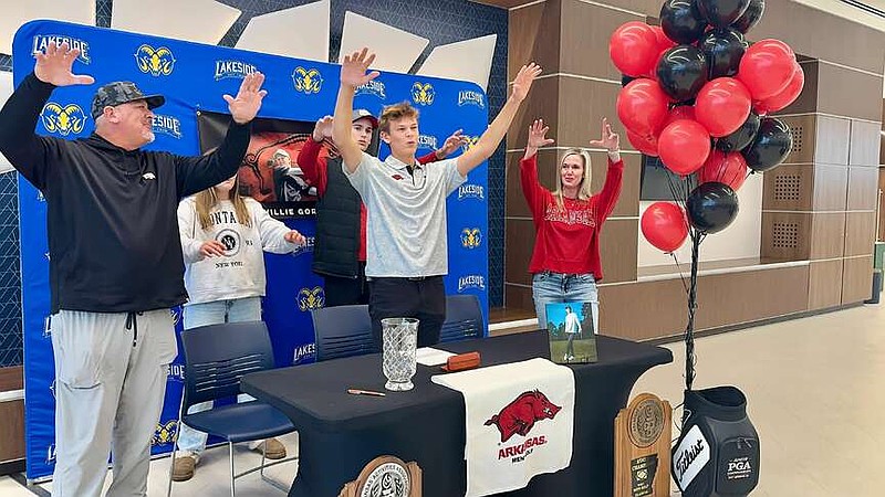 Lakeside senior golfer Will Gordon, center, calls the hogs with friends and family in the Lakeside Performing Arts Center on Wednesday at his signing day. (The Sentinel-Record/Bryan Rice)