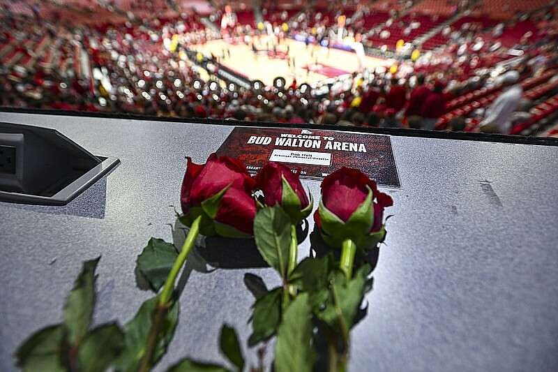 A memorial for Arkansas Democrat-Gazette sportswriter Bob Holt is shown on press row Saturday at Walton Arena. Seats at the press table and in the arena's media room held roses and featured placards holding the space for Holt, who died Wednesday. (NWA Democrat-Gazette/Hank Layton)