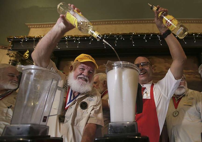 Charlie Boice, center, winner of the 2015 "Papa" Hemingway Look-Alike Contest at Sloppy Joe's Bar in Key West, prepares a Daiquiri at La Floridita bar recalling passages from the life and work of 1954 Nobel Prize-winning writer Ernest Hemingway, in Havana, Cuba, Saturday, Dec, 6, 2024. (AP Photo/Ariel Ley)