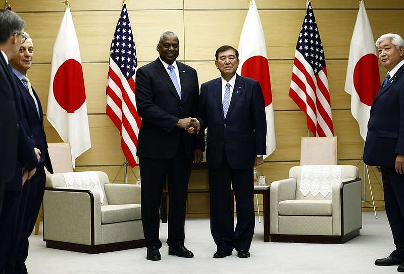 U.S. Defense Secretary Lloyd Austin, left, shakes hands with Japan's Prime Minister Shigeru Ishiba at the start of their bilateral meeting at the prime minister's official residence in Tokyo, Japan, Tuesday, Dec. 10, 2024.(Issei Kato/Pool Photo via AP)