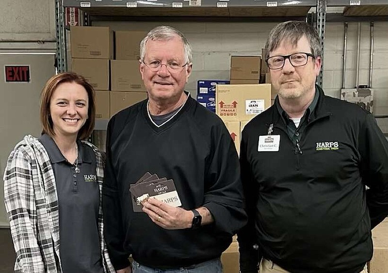 From left, Brandilynne Crosby, grocery manager at Harps 394, Ted Thompson, Director of Project HOPE Food Bank, and Christian Crosby, store manager at Harps 391, are shown at a grant presentation from Harps Food Stores to Project HOPE Food Bank. (Submitted photo)