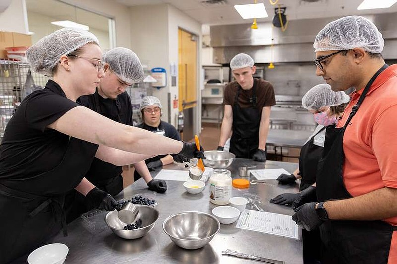 Dallas College HUGS instructor Rachael Randel helps prepare blueberry muffins with students Oct. 29, 2024, at Dallas College. (Azul Sordo/The Dallas Morning News/TNS)