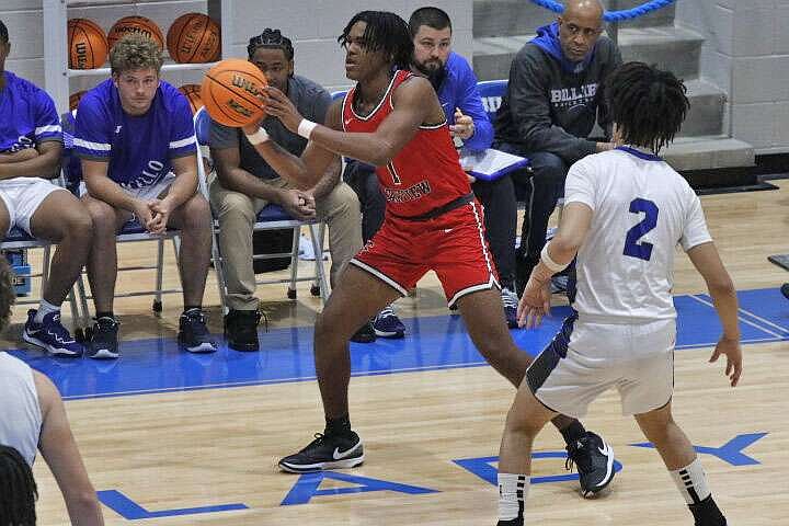 Darre'll Juney Atkins passes the ball around the perimeter during a game against Monticello. (Photo by Patric Flannigan)