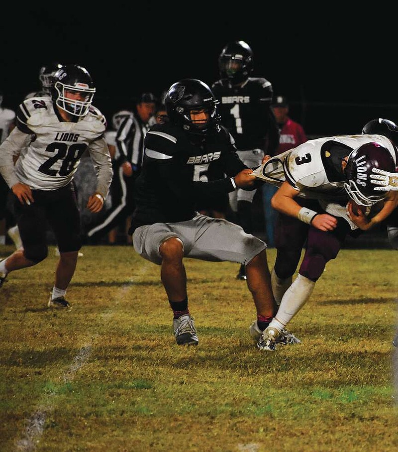 Photo by Britney Layne
Bearden's Matthew Chambers (5) wrangles a Mt. Ida ball carrier during the playoffs. The two-way student athlete was named to the 2A All State Team this year.