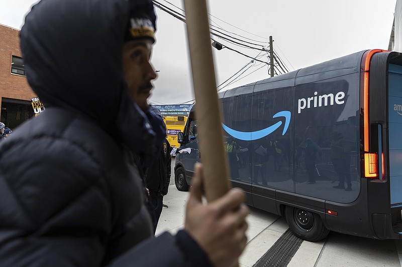 Amazon workers and members of the International Brotherhood of Teamsters picket in front of the Amazon fulfillment center in the Queens  borough of New York, Friday, Dec. 20, 2024. (AP Photo/Stefan Jeremiah)