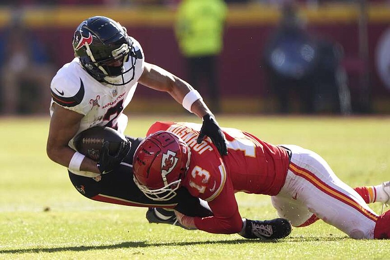 Houston Texans wide receiver Robert Woods (2) is tackled by Kansas City Chiefs cornerback Nazeeh Johnson (13) during the first half of an NFL football game Saturday, Dec. 21, 2024, in Kansas City, Mo. (AP Photo/Charlie Riedel)