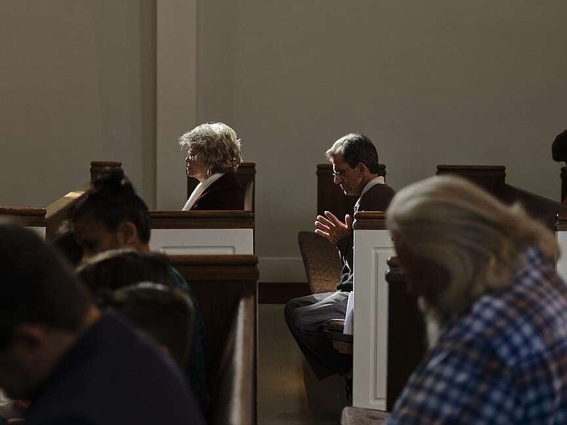 Worshipers pray during Sunday's service at First Christian Church of North Hollywood. The California congregation is politically diverse and aiming to stay united despite those different views. MUST CREDIT: Philip Cheung for The Washington Post