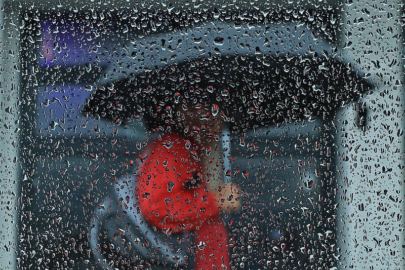 A pedestrian carries an umbrella on President Clinton Ave. in downtown Little Rock as a light rain falls over the area Monday, Sept. 16, 2024. (Arkansas Democrat-Gazette/Colin Murphey)