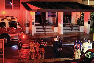 Emergency personnel remain on the scene Tuesday Dec. 31,2024 after a fire at the Midtown Park Apartments at 6115 W. Markham Street in Little Rock. (Arkansas Democrat-Gazette/Staton Breidenthal).